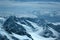 Panorama of snowy mountains and high alpine peaks in wintery Bernese Oberland in Switzerland