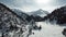 Panorama on the snowy peak of the peak that is in the distance of the gorge covered with snow. Along the sides of the gorge there