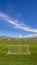 Panorama Soccer field with scenic view of towering mountain and vibrant blue sky