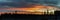 Panorama on spectacular extremely red orange colored sunrise over the Scandinavian pine tree forest, totally calm weather, forest