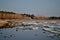 Panorama of the spring beach on the Volga river and the beginning of the ice drift in sunny weather.