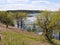 panorama spring flood fields flooded with water trees with young greenery on a hillock