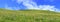 Panorama of spring grassland under the sky