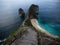Panorama of stairs at Kelingking Beach blue turquoise tropical ocean limestone cliff Nusa Penida Island Bali Indonesia