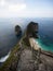 Panorama of stairs at Kelingking Beach blue turquoise tropical ocean limestone cliff Nusa Penida Island Bali Indonesia