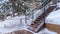 Panorama Stairs and wooden deck on snowy hill with decorative and colorful string lights