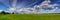 Panorama of the summer field and sky with clouds