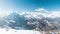 Panorama from summit on snow capped mountain peaks and ridges of the Alps