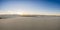 Panorama Of Sun Setting Over The Vast Emptiness of White Sand Dunes