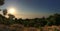 Panorama of sunset above valley of clouds with nature in foreground