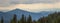 Panorama of sunset in Carpathian mountains with tops of pine trees