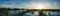 Panorama of sunset landscape over flooded land next to a levee