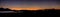 Panorama of Sunset in Milos bay with Adamas and Plaka lights