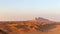 Panorama of sunset over Fossil Rock mountain ridge and golden desert dunes, Sharjah, United Arab Emirates