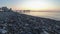 Panorama of the Sunset over the Sea. Stone Beach Shore with Sea Waves.