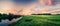 Panorama of sunset on the river and field