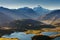 Panorama at sunset of Roys Peak between Wanaka and Queenstown with a lake and Mount Aspiring and cook of the new zealand alps.