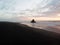 Panorama sunset view of Paratahi Island rock on black sand Karekare Beach West Auckland North Island New Zealand