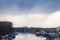 Panorama of Tamis river, on Pancevo Waterfront in city center during a rainy afternoon with boats and typical rafts, called spalv