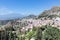 Panorama Taormina with southward view smoking Etna volcano, Sicily, Italy