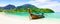 Panorama of thai traditional wooden longtail boat and beautiful sand beach