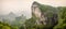 Panorama of the Tianmen Mountain Peak with a view of the cave Known as The Heaven`s Gate surrounded by the green forest and mist