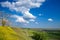 Panorama of Titelski breg, or titel hill, in Vojvodina, Serbia, with a dirtpath countryside road in front of a yellow field