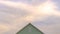 Panorama Top exterior of a house with view of the light green wall and gable vent