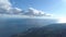 Panorama from top of mountain to city. Shot. Top view of coastal city by sea. Beautiful blue sea landscape with blue sky