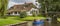 Panorama of tourists in an electric boat in the canals of Giethoorn