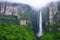 panorama of a towering waterfall draped in mist