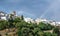 panorama of the town of Mairena of the Alpujarra with white houses, church tower and a rainbow