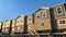 Panorama Townhouses with brick wood and concrete wall against blue sky on a sunny day