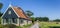 Panorama of a traditional dutch house in the landscape of Texel
