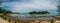 Panorama of tropical rocky beach with boats in lagoon. Thailand. Ocean. Summer. Hills.