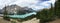 Panorama of turquoise Peyto Lake in the Canadian Rockies surrounded by mountains; landscape
