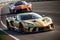 Panorama of Two Sports Racing Cars Battling on the Race Track. AI generated