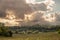 Panorama of a typical serbian rural landscape with farm estates, grass fields, buildings and barns surrounded by fields in the