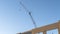 Panorama Unfinished building exterior and construction crane with blue sky background