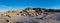 Panorama of unusual rocks and boulders scattered across the floor of a barren desert