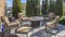 Panorama Upholstered metal chairs and round table at the patio of a home under blue sky