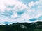 Panorama in Vado with green high mountains white clouds and beautiful sky