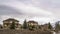 Panorama Vast cloudy sky over residential area built on snowy hill with coniferous trees