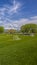 Panorama Vast sports field with soccer goal net and baseball bleachers behind a fence