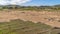 Panorama Vast terrain with grasses against hills and blue sky with clouds background