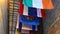 Panorama Vibrant colorful decorative flags against corrugated metal roof of building