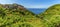 A panorama view across the fields and picturesque Cinque Terre village of Corniglia, Italy