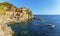 A panorama view across the rocky coastline towards the village of Manarola, Cinque Terre, Italy