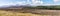 A panorama view across the rugged terrain on the island of Skye towards the flat topped mountains of MacCleods tables, Scotland