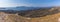 A panorama view across the volcanic island of Nea Kameni, Santorini towards Palea Kameni in the background